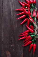 Gardinen Chilischoten Hot red chili peppers on a dark wooden background  © Ekaterina Petrukhan