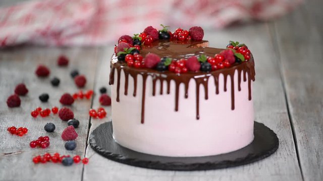 Slice of milky girl cake topped with with berry.
