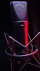 studio condenser microphone, isolated on black. with Red light