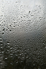 Windowpane in rain drops.