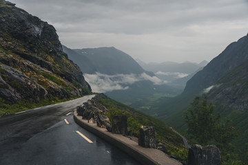 Serpentine road in the mountains of Norway, Trollstigen, troll staircase, gloomy gloomy weather, wet asphalt