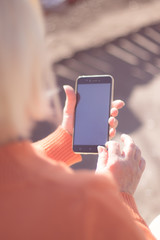Happy woman using social media on her smartphone