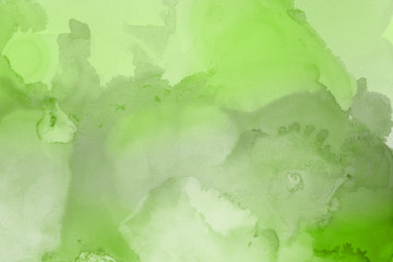 Hand painted alcohol ink background. Abstract delicate green texture. Contemporary wallpaper. 
