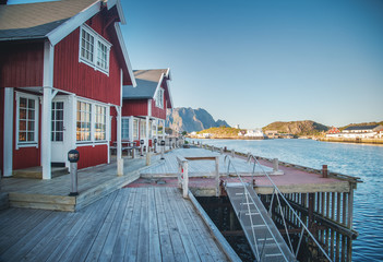 View Scrova island on the Lofoten, Norway,  beautiful bright landscape, traditional red houses of Rorbu