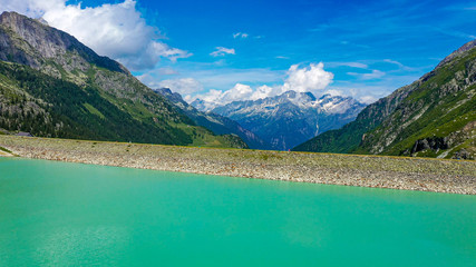 Naklejka na ściany i meble Amazing turquoise water of a glacier lake in Switzerland