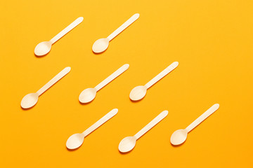 Ecological disposable tableware on an orange background. zero ecology