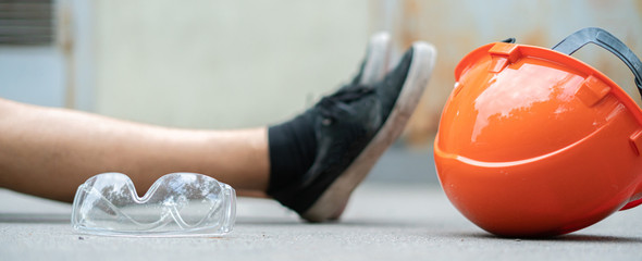 fallen worker on the floor with his helmet, accident injury