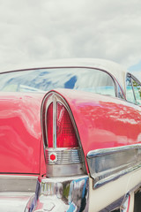 Rear end of a pink classic car