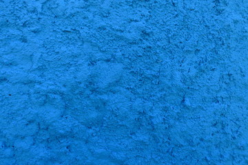 Fototapeta na wymiar Détail de surface granuleuse de mur bleu.