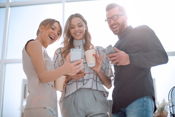 business team looking at the screens of their smartphones