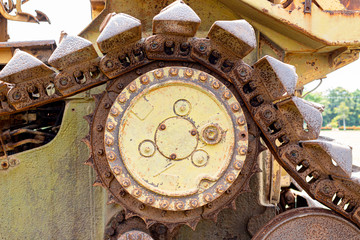 Fototapeta na wymiar cogwheel of the Old tractor , crawler wheel