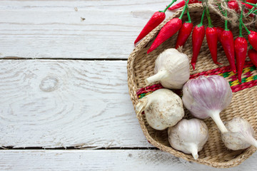 Chili pepper and garlic on a light wooden background