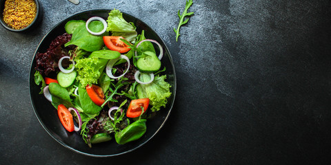 Healthy salad, leaves mix salad (mix micro greens, cucumber, tomato, onion, other ingredients). food background. copy space