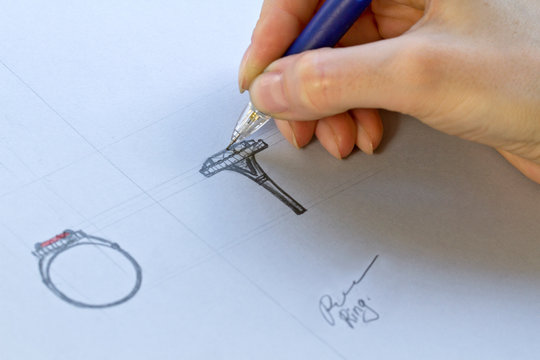 Drawing Jewelry Design. Artist designer drawing sketch jewelry on paper . Hand made.