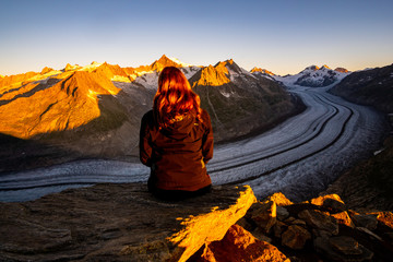 girl enjoying the view over the Aletsch Glacier in the Swiss alps