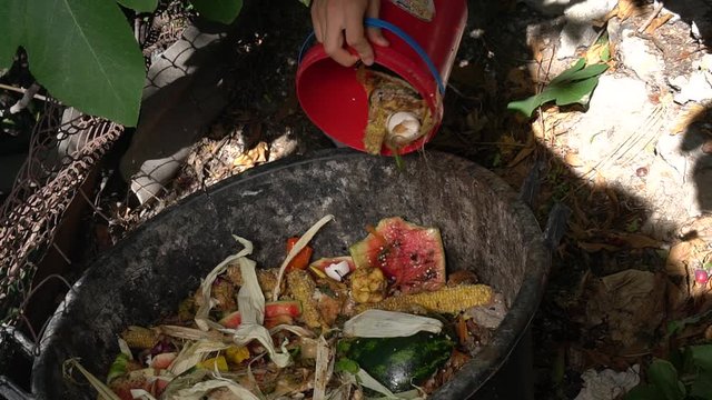 Compost bin. Backyard Composting. Zero Waste: refuse, reduce, reuse, recycle, rot. Man composting kitchen waste