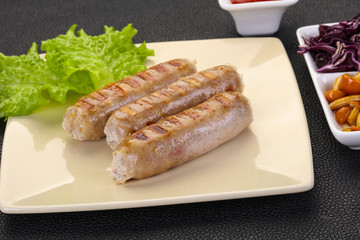 Grilled sausages served mushrooms and cabbage