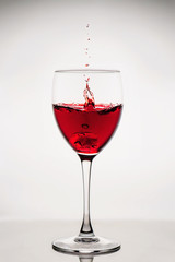 Red wine splash in the wineglass