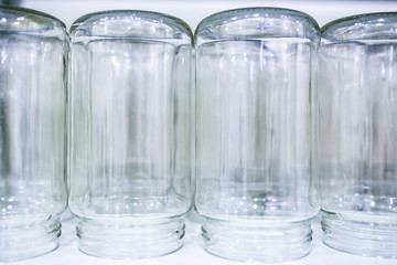 Upside down sterilized glass jars prepared for food conservation process.