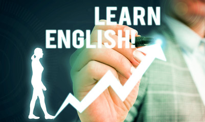 Handwriting text writing Learn English. Conceptual photo gain acquire knowledge in new language by study Female human wear formal work suit presenting presentation use smart device
