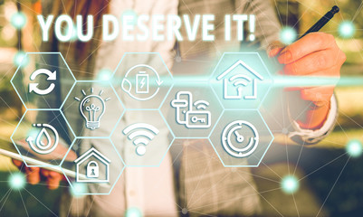 Word writing text You Deserve It. Business photo showcasing should have it because of their qualities or actions Female human wear formal work suit presenting presentation use smart device
