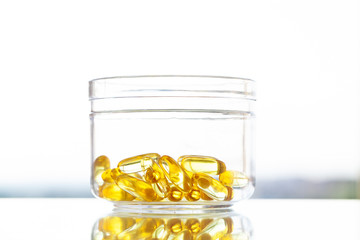 Vitamins supplements, fish oil in yellow capsules omega 3.