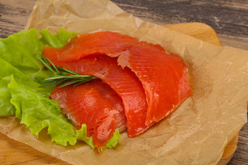 Sliced salmon fillet served rosemary