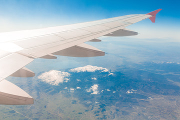 Obraz premium Wing of an airplane. Traveling concept. Aircraft wing on the clouds