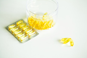 Vitamins supplements, fish oil in yellow capsules omega 3.