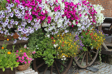 Flowery exterior home decoration with old wooden wheels