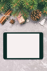 Digital tablet mock up with rustic Christmas gray cement background decorations for app presentation. top view with copy space. Toned