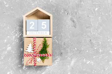 Calendar with date 25 december and gift boxes on color background. Christmas concept
