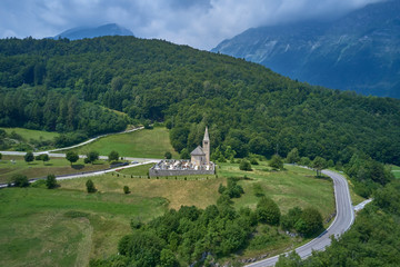 Fototapeta na wymiar Aerial photography. Panoramic view of the Alps north of Italy. Trento Region. Great trip to the Alps. Cemetery is located on a hill.
