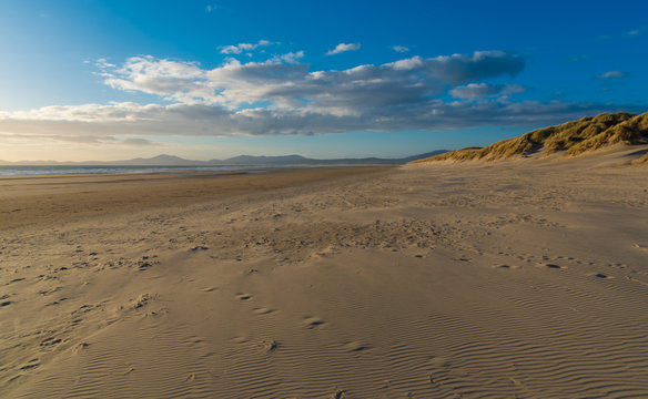 Views along the beach with sand dunes and mountains in the distance, Harlech, North Wales
