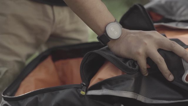 Guy showing his pannier bags on a motorbike, dolly close up