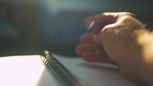 Close up of a man's hand trying to write something, tapping the pen and then putting pen down