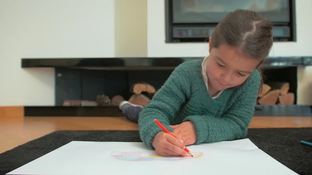 Footage from a young girl drawing in a white papper. 4K video fottage