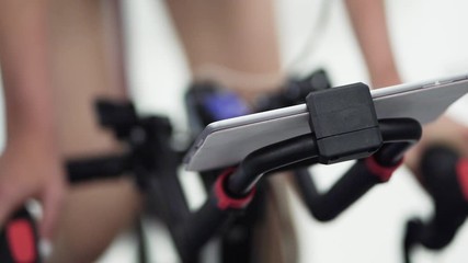 Sport medicine research. Athlete doing testing by cycling in modern high-tech Sport Science laboratory. Sport professional analyzing exercise bicycle - Powered by Adobe