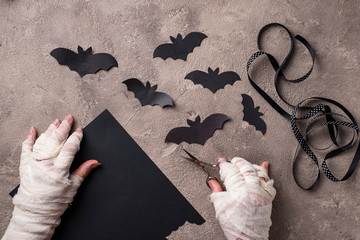 Mummy makes bats out of paper