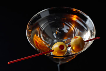 Martini cocktail with green olives.