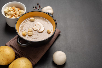 Champignon mushroom cream soup in a black bowl