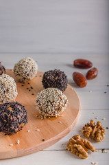 vegetarian food, energy balls of walnuts, dates, prunes, cranberries, honey with sesame