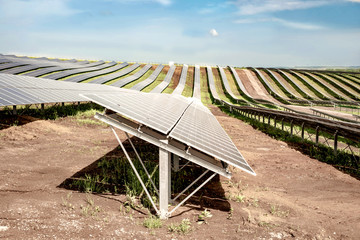 Rows of solar panels on the steep hills of the field