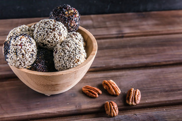 vegetarian food, energy balls of pekan, dates, prunes, cranberries, honey with sesame