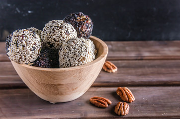 vegetarian food, energy balls of pekan, dates, prunes, cranberries, honey with sesame