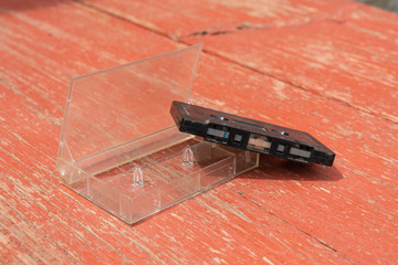 old black film audio cassette on a wooden table