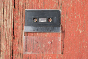 old black film audio cassette on a wooden table