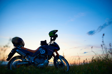 Fototapeta na wymiar MOTORCYCLE WITH A HELMET ON A MOUNT