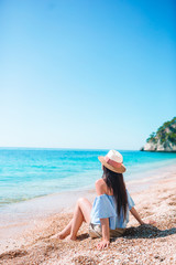 Woman laying on the beach enjoying summer holidays looking at the sea