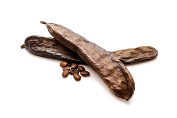 Carob fruit isolated on white background